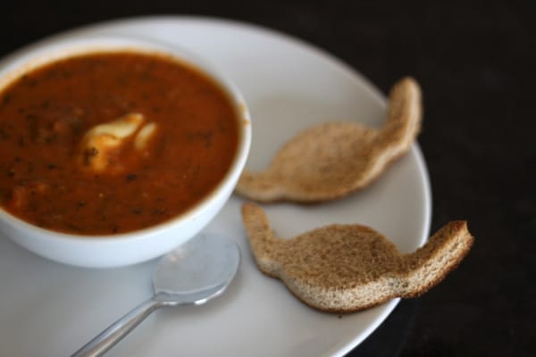 tomato basil spinach soup with cheese tortellini and bat croutons