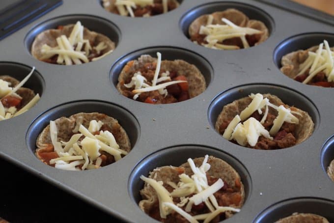 mini taco cups sprinkled with cheese